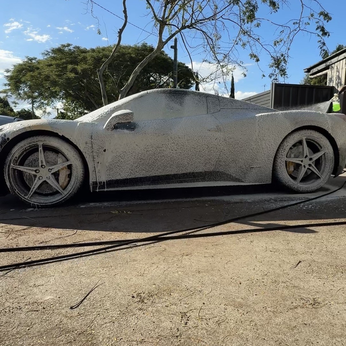 Snow foam pre-wash on a Ferrari during a mobile detail in Brisbane